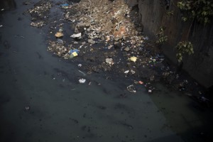 Polluted water runs through a sewer in the Dharavi slum area of Mumbai, India. Only 26 percent of the 6 billion gallons of sewage generated daily in India is treated.